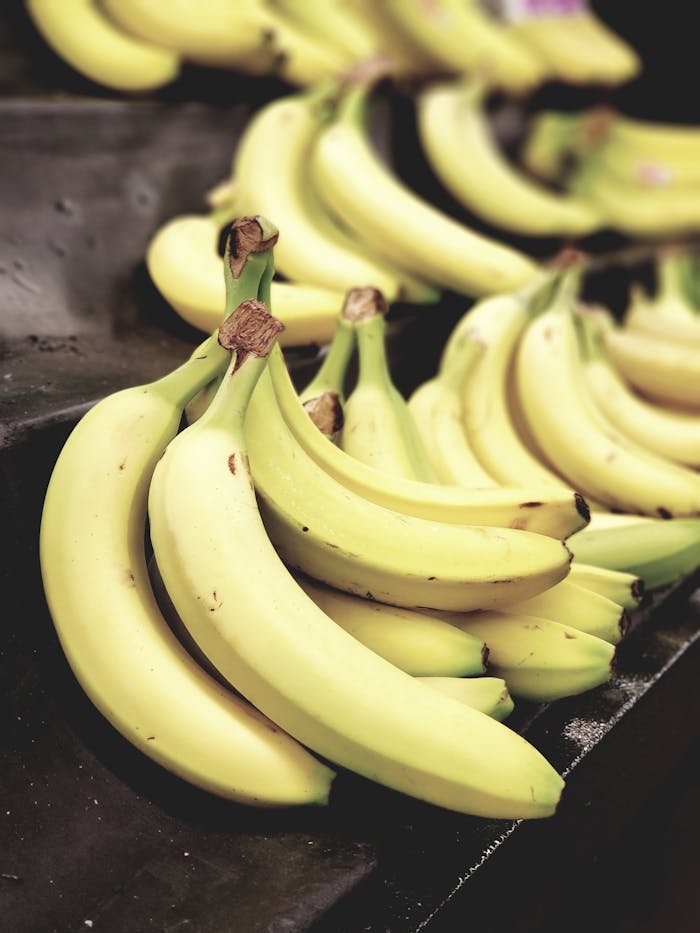 Close-up shot of vibrant yellow bananas on display, highlighting freshness and nutrition.