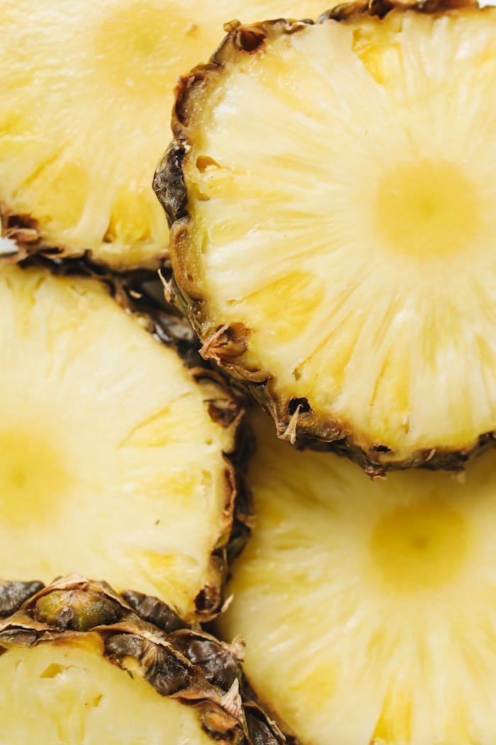 Vibrant close-up of fresh pineapple slices displaying juicy texture. Perfect for tropical themes and healthy food concepts.