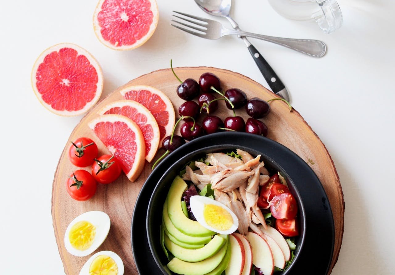 Crafting Captivating Headlines: Your awesome post title goes here A vibrant breakfast flat lay featuring a mix of fruits, avocado, eggs, tomatoes, and sliced meats on a wooden platter.